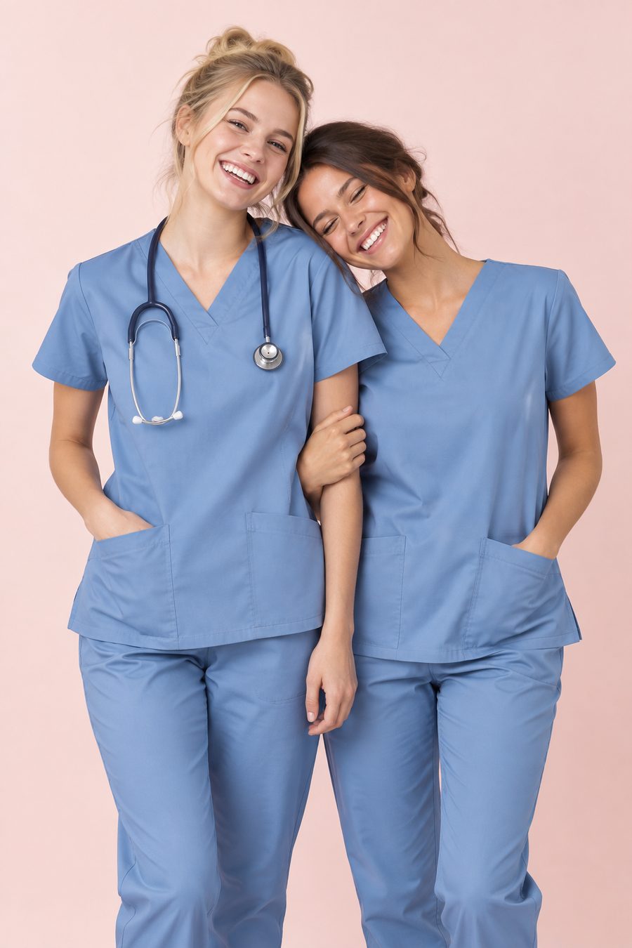 Two smiling nurses in blue scrubs